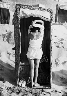 Vacationer: Beach chair as changing cabin, 1926