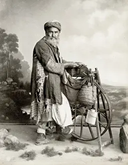 Grind: Bearded Egyptian man sharpening knives on grind stone