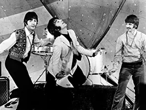 The Beatles dancing on stage without their instruments