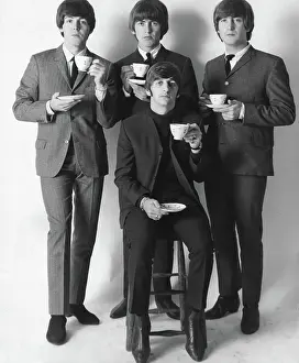 Fabulous: The Beatles pop group with cups of tea, New York