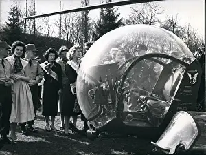 Pleasures: Three beauty queens looking at a helicopter, Germany