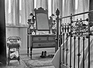 Bedstead: Bedroom interior with dressing table and bed