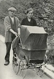 Beggar couple with child in pram