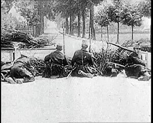 Ducking: Belgian Soldiers Ducking Behind A Low Barricade