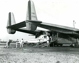Fairchild: A Bell Model 47J being loaded into a Fairchild C-82 of t