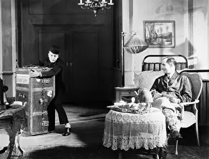 Helpful: Bellboy struggling with trunk in guests room