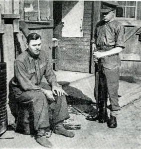 Belsen: Belsen camp commander under British guard, WW2