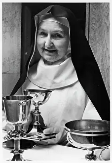 Cares: Benedictine nun with holy vessels