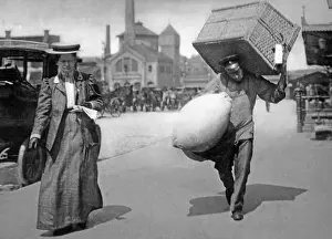 Attendants: A Berlin porter carrying suitcases, 1909