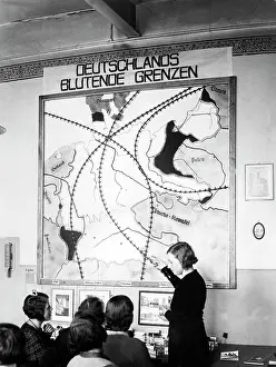Entitled: Berlin school children are looking at a map of Germany, 1932