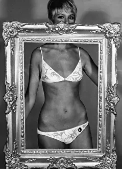 Bikinis: A bikini-clad woman holding a frame