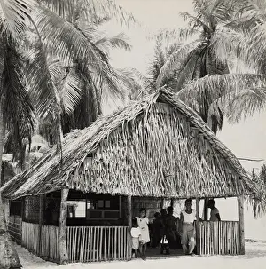 Micronesia: Bikini Islanders in their thatched roof home, ca