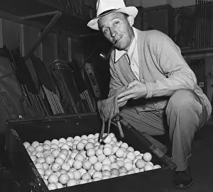 Contributes: Bing Crosby contributes his golf balls the World
