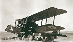 Sepia Images: Biplane bomber with crew and arabs in the desert, Iraq