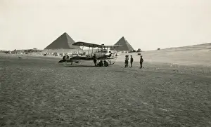 504k: A biplane in the Egyptian desert, with the pyramids
