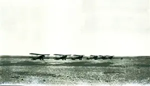 Sepia Images: Six biplanes lined up in the desert, Iraq