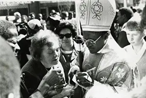 Emeritus: Bishop Desmond Tutu writing and wearing religious