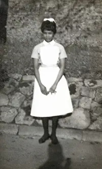 Slams: Black nurse standing by a wall in the grounds of Woman's Hos