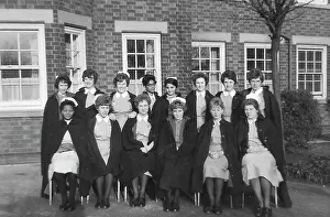 Black nurses amongst white nurses having a group picture