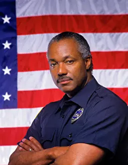Del003: Black Policeman Looking at Camera Standing in
