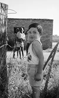 Zanu: Black and white photo of children playing on cattle