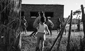 Zanu: Black and white photo of children playing on cattle