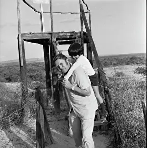 Piggyback: Black and white photo of a man giving a young