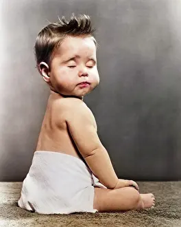 Nonchalant: Blase Bored Baby Seated with Back To Camera Turning