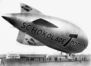 Advertises: A blimp with a chocolate ad, 1930