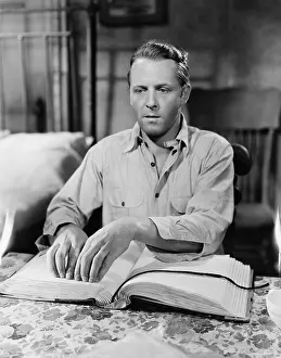 Impaired: Blind man reading book in Braille