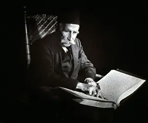Braille: Blind man reading a Braille book, ca. 1938.?