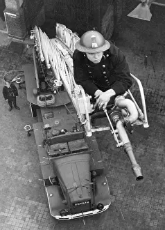 Blitz in London -- AFS firefighter on ladder, WW2