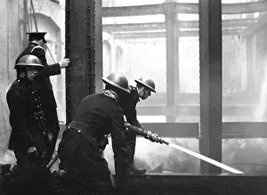 Gutted: Blitz in London - Firefighters at work with hosepipe, WW2
