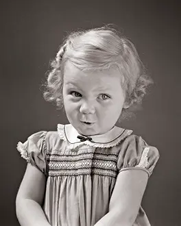 Pleasing: Blond Toddler Girl Looking at Camera up and To