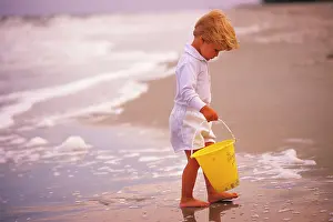 Entranced: Blonde Boy Dressed in White with Yellow Plastic