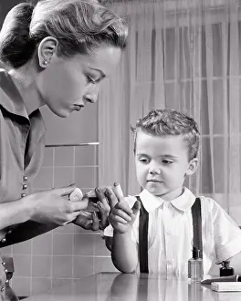 Administering: Blonde Mother Administering First Aid Using Bandage