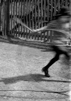 Blurry: Blurred image of child with hoop and stick