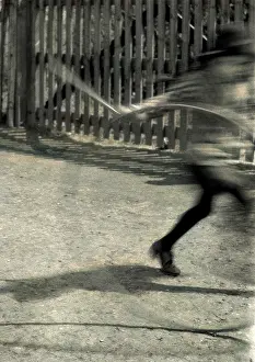 Blur: Blurred image of child with hoop and stick