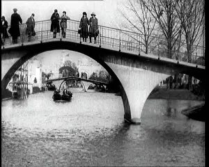 Wembley: A Boat Sails Alongside The River Thames Under