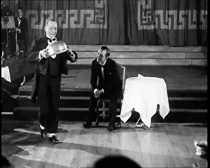 Howes: Bobby Howes Performing a Comic Routine With a Waiter