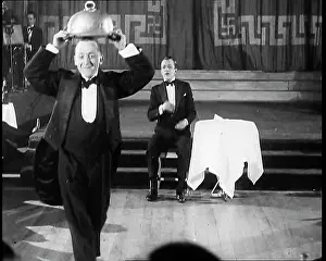 Howes: Bobby Howes Performing a Comic Routine With a Waiter