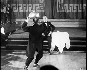 Howes: Bobby Howes Performing a Comic Routine With a Waiter