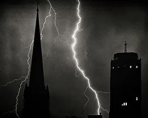 Electrostatic: Two Bolts of Lightning in Night Sky Behind Silhouetted