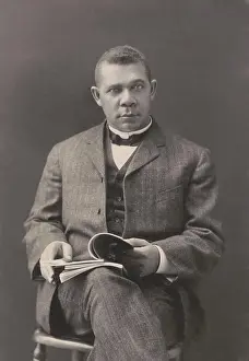Intolerance: Booker T. Washington sits with books on his lap