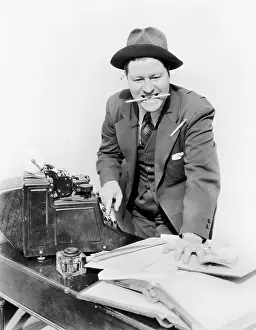 Pencils: Bookkeeper with adding machine and pencil in his mouth