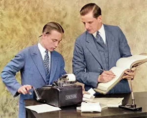 Manly: Bookkeeper and Young Assistant in Office Using