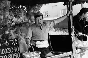 Raffle: Bored looking fairground stall attendant