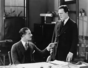Dismissing: Boss pointing finger at staff in office
