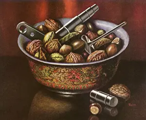 Nuts: A bowl of walnuts and assorted nuts with nutcracker tools