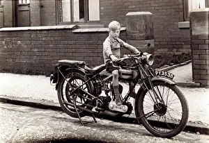 Curb: Boy on a 1923/4 Triumph motorcycle